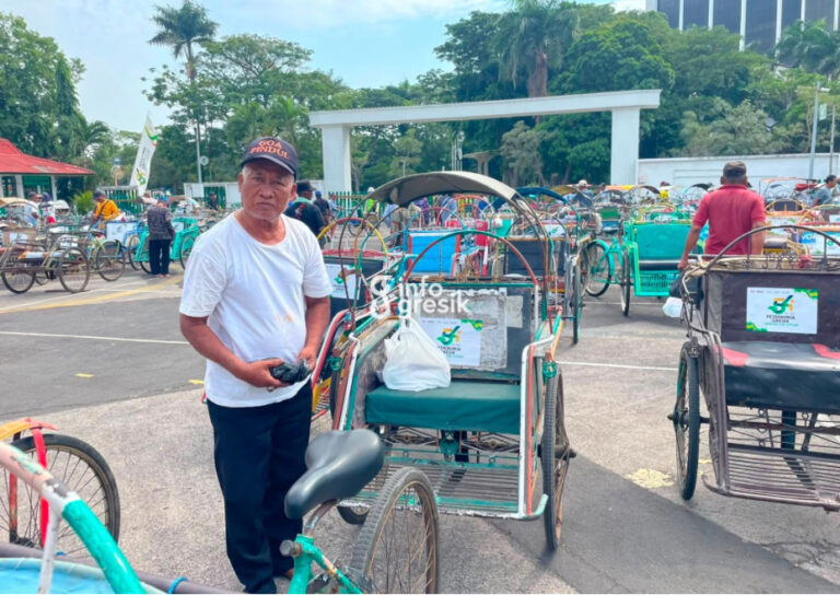 Salah satu pengayuh becak menerima bantuan dalam rangka HUT ke-54 PT Petrokimia Gresik. (Foto: Ist/Infogresik)