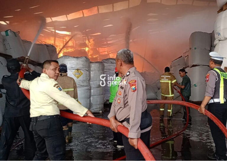 Petugas gabungan bahu-membahu memadamkan api di gudang PT Wings Surya. (Foto: Ist/Infogresik)
